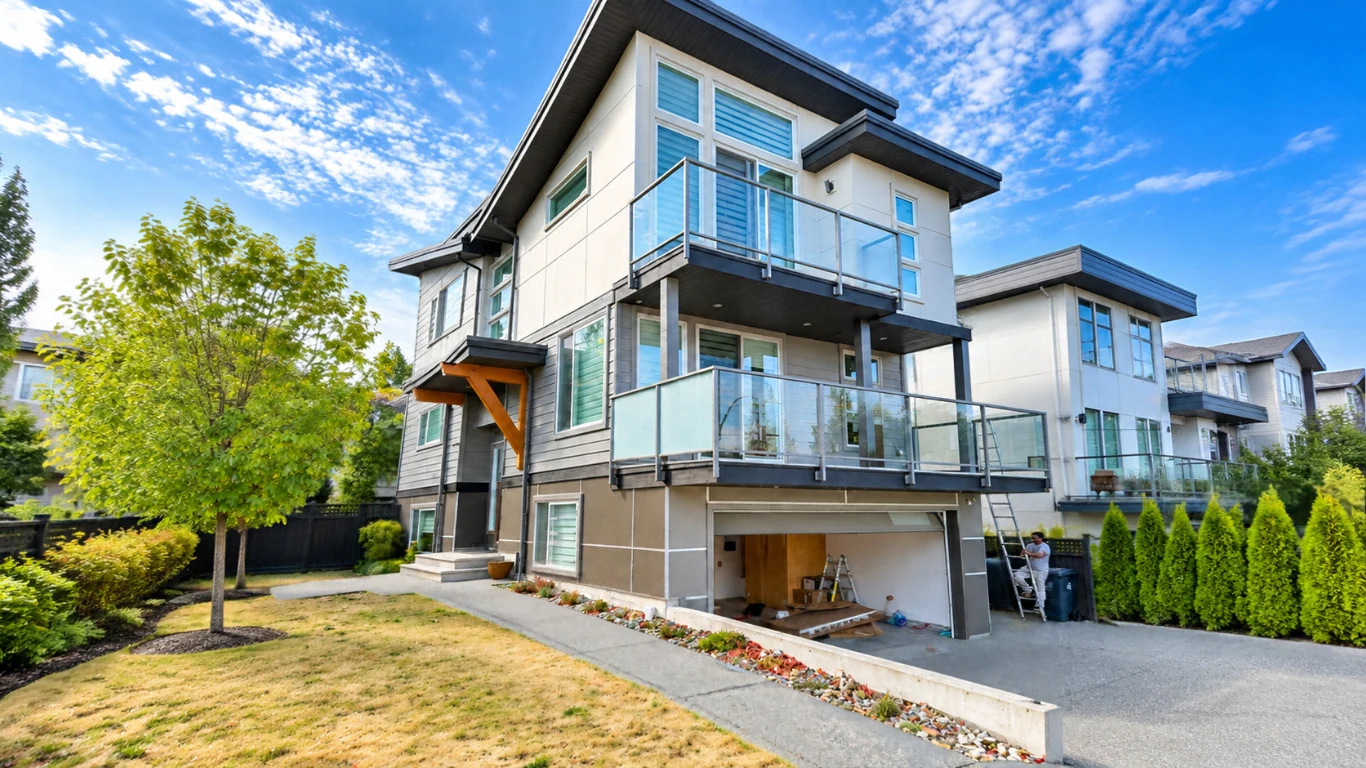 Completed residential exterior with finished siding, trim and surrounding property details.
