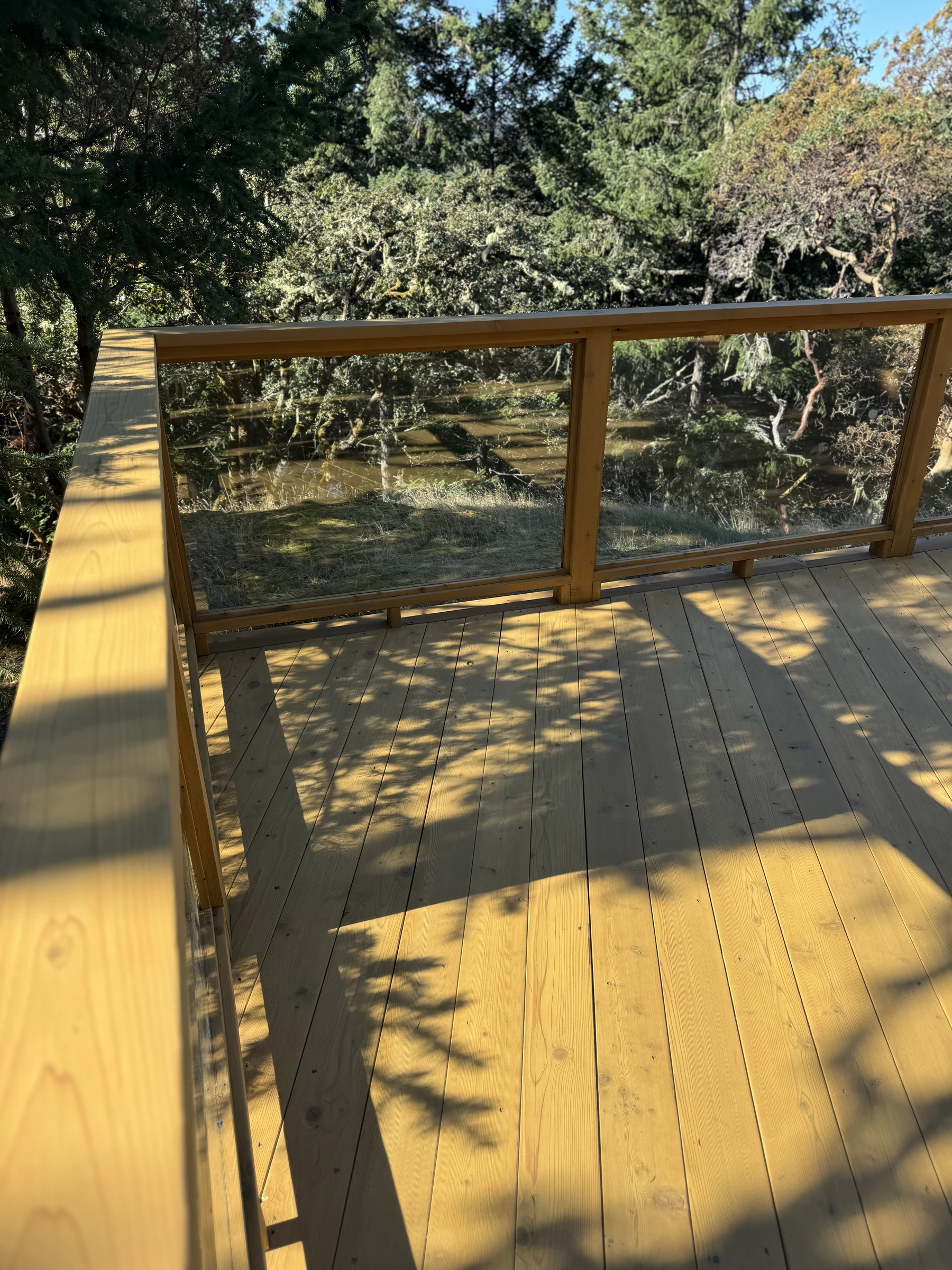Finished deck and railing with a protective wood-staining finish